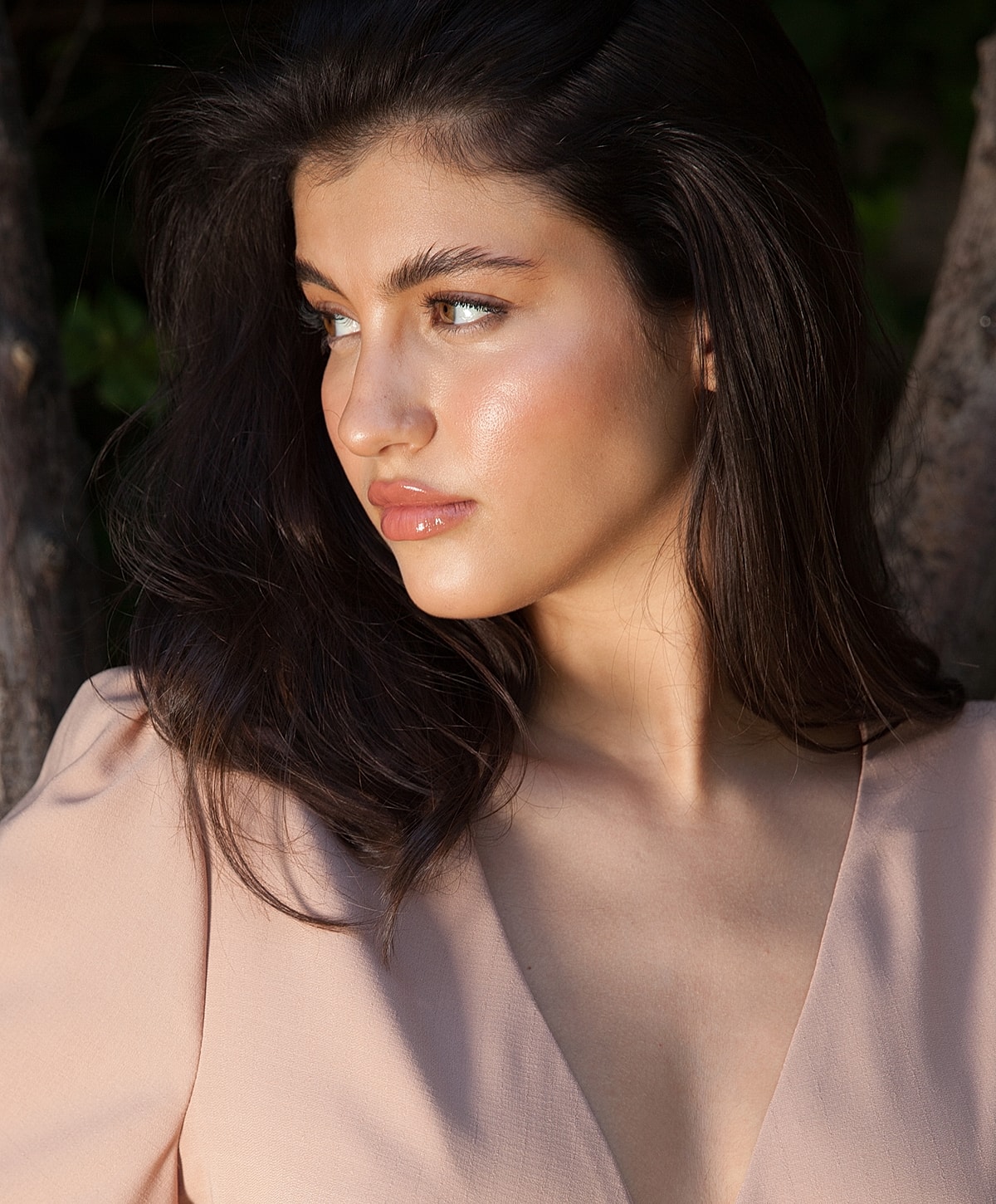 Young woman with long hair in natural light.
