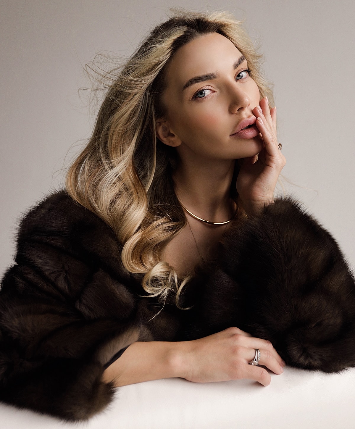 Woman in fur coat with elegant jewelry.